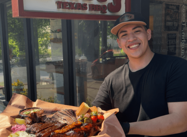 a person holding a platter from 2fifty bbq