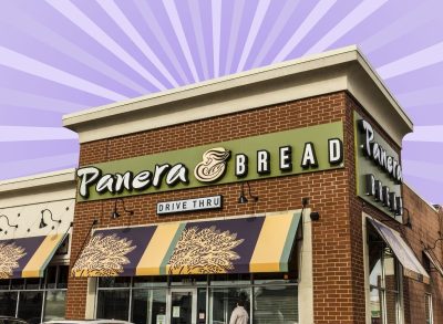 The storefront of a Panera Bread restaurant set against a vibrant purple background.