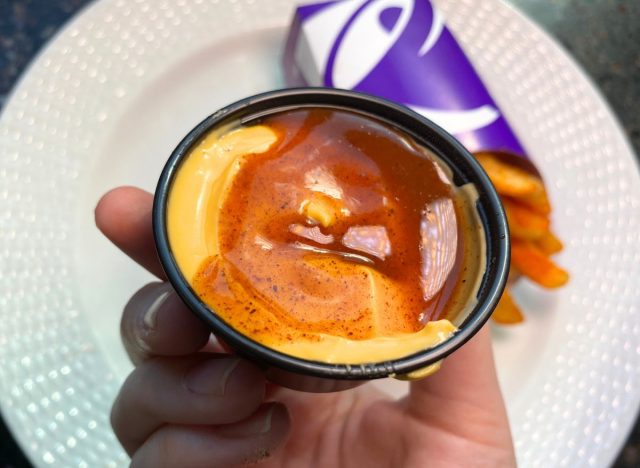 Taco Bell nacho cheese cup with hot sauce drizzled on top