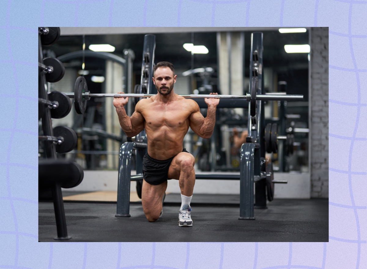 fit, muscular man doing barbell lunge in the weight room at the gym