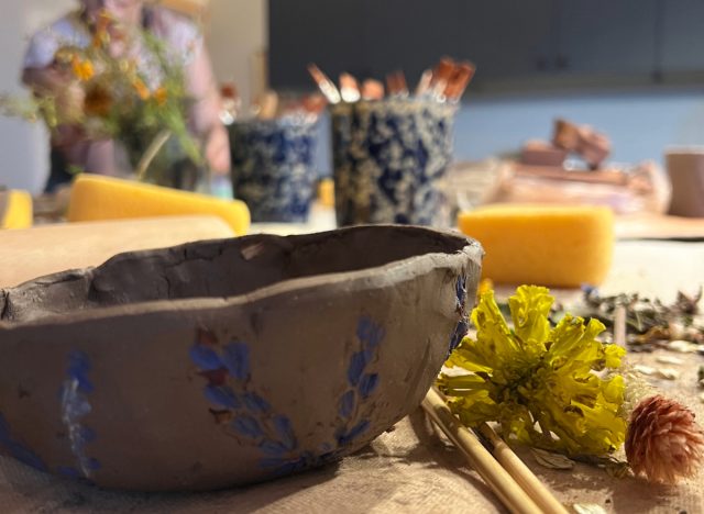 botanical pottery class close-up of clay creation and flowers