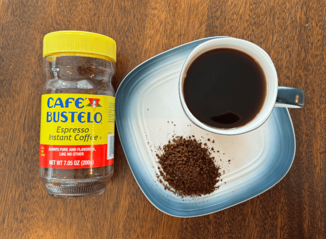 can of cafe bustelo next to a mug of black coffee 