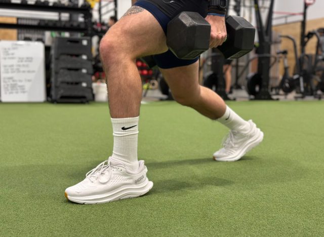 close-up of HOKA sneakers, man doing walking dumbbell lunges