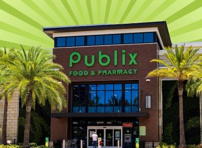 The storefront of a Publix supermarket set against a vibrant green backgorund.