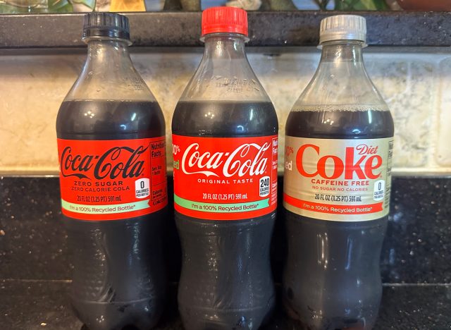 diet coke vs coca cola vs coke zero bottles on a counter