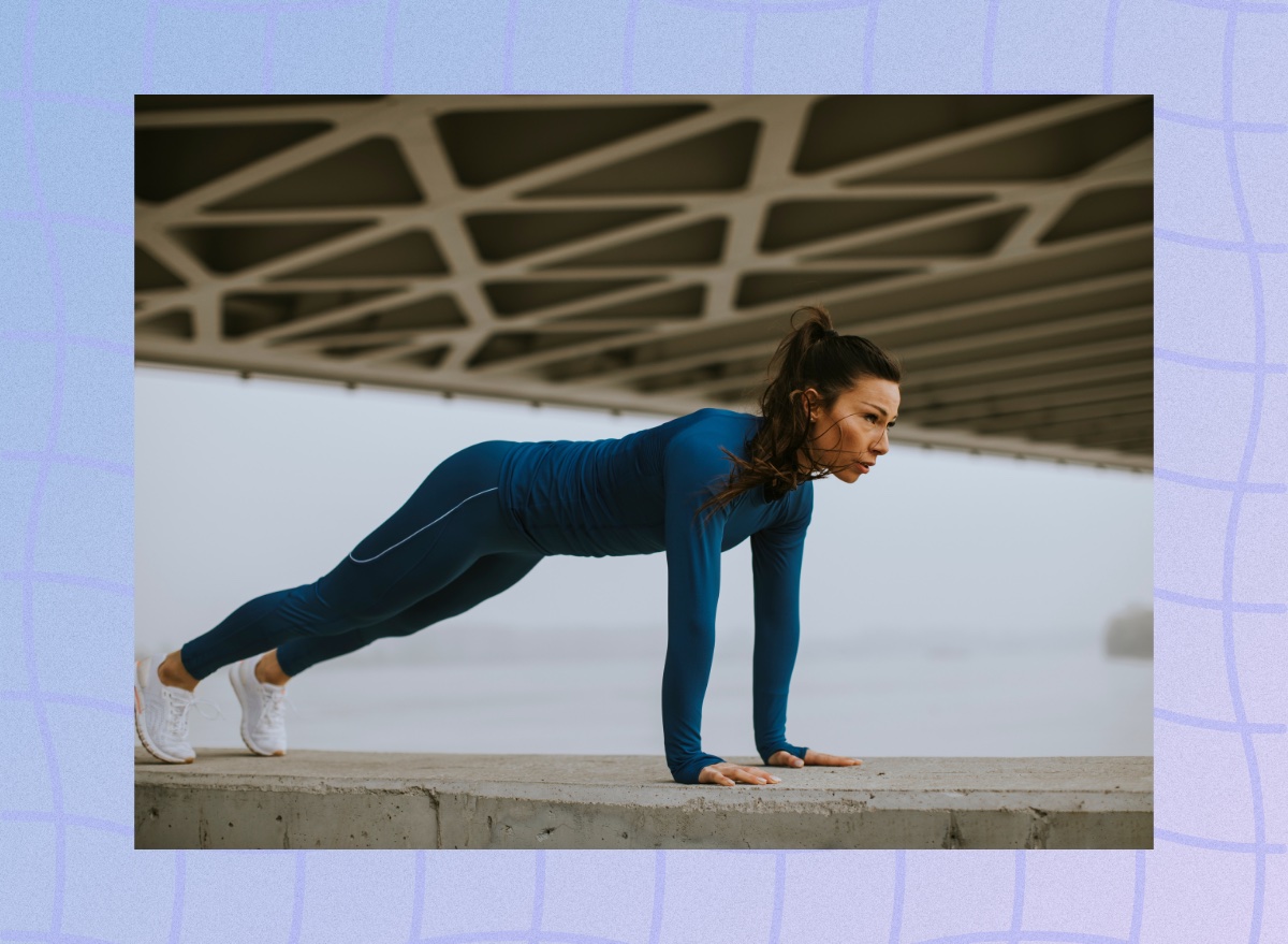 fit, focused brunette woman doing pushups outdoors under bridge