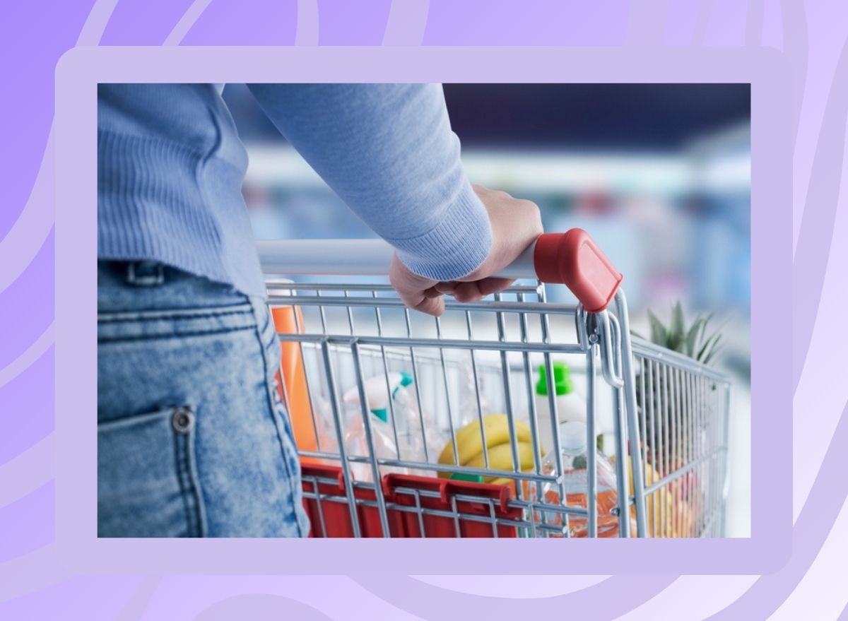 photo of grocery shopper pushing cart on patterned purple background