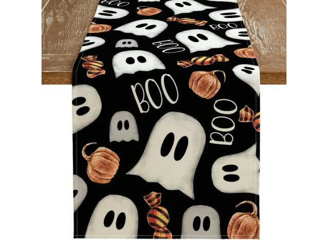 a table runner imprinted with ghosts and the word boo