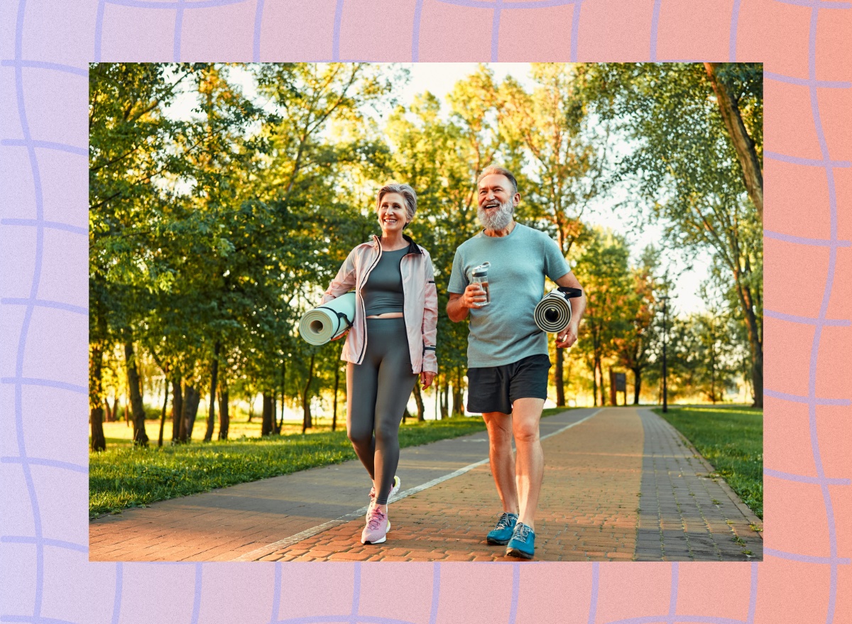 happy, mature couple walking in park on sunny day on way to yoga class