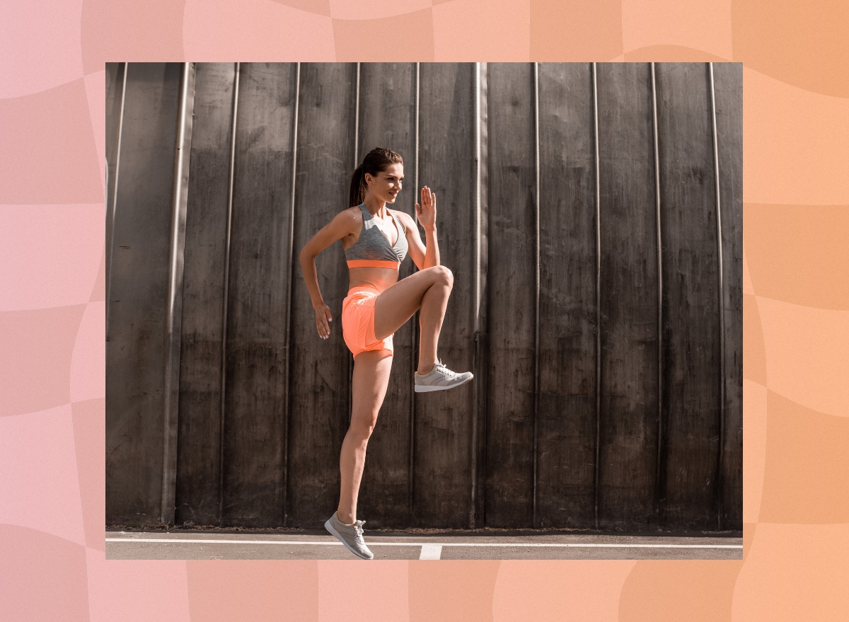 woman doing high knees exercise outdoors