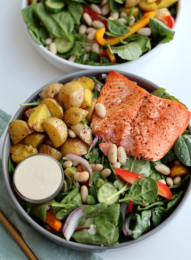 high protein salmon salad with roasted baby potatoes, beans, spinach, avocado with creamy lemon dressing