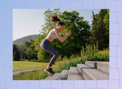 fit woman doing jump squat exercise on stairs outdoors