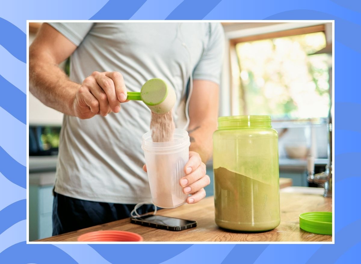 man making a protein shake on a blue background