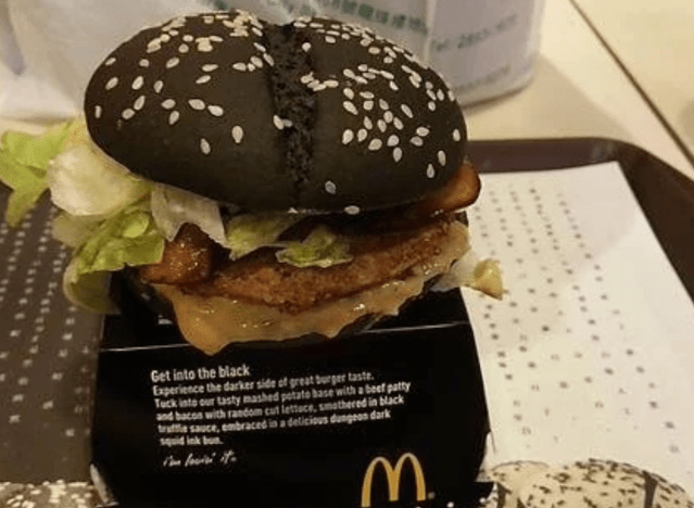 a mcdonalds burger with a black bun