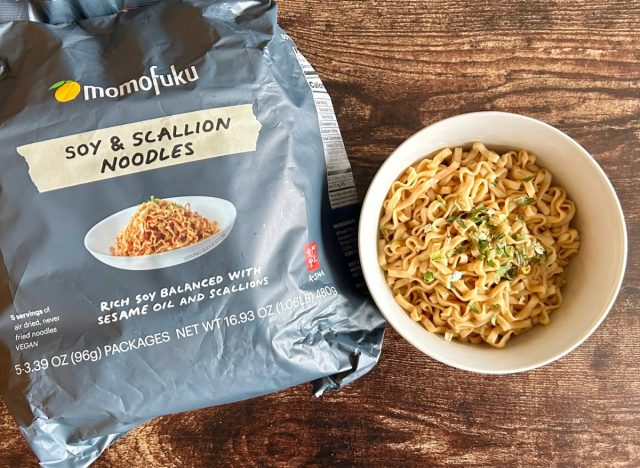 momofulu soy & scallion noodles in a bowl next to a package of the noodles