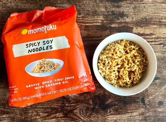 momofuku spicy soy noodles in a bowl next to a package of the noodles