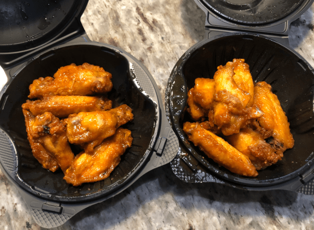 two orders of pizza hut wings on a table 