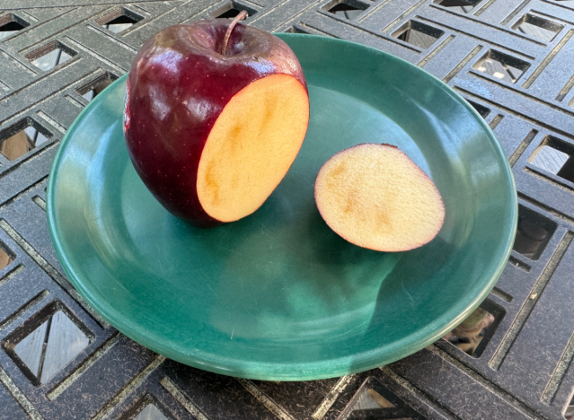 red delicious apple cut open on a plate 