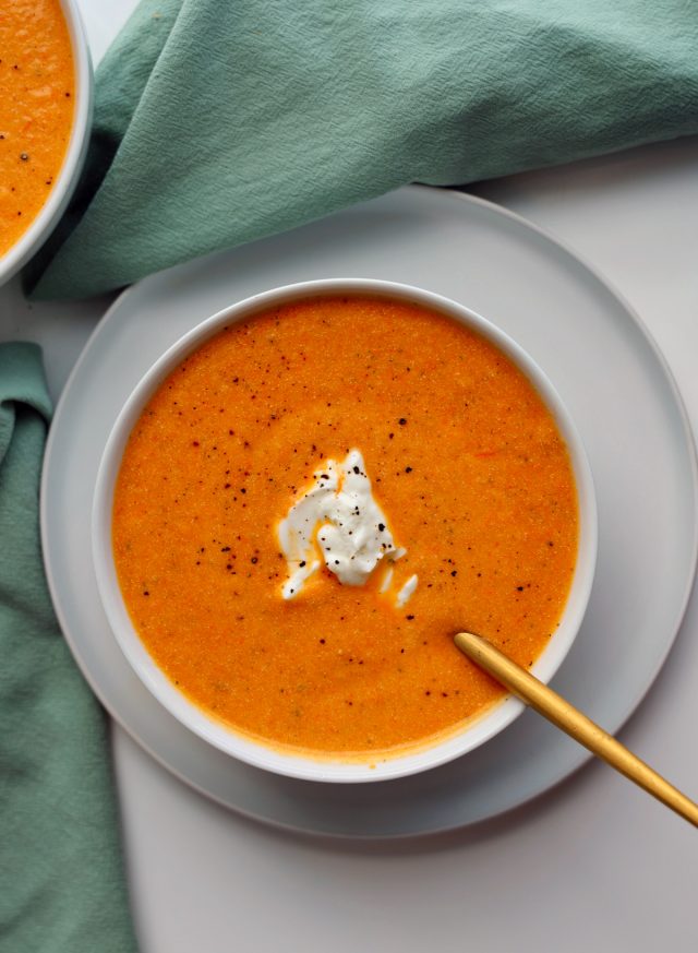 roasted vegetable soup overhead in bowl on table with teal napkin