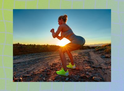 fit woman doing squats outdoors at sunset along dirt road