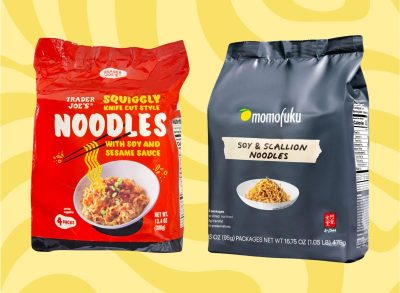 packages of trader joe's squiggly knife cut style noodles and momofuku's soy & scallion noodles set against a yellow background