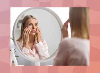 middle-aged woman looking at face in mirror