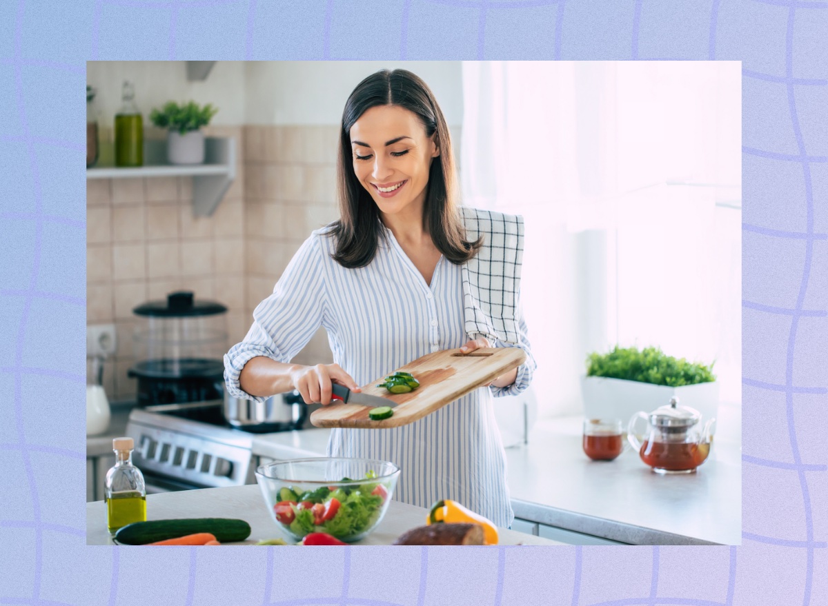 happy woman preparing healthy salad in bright kitchen