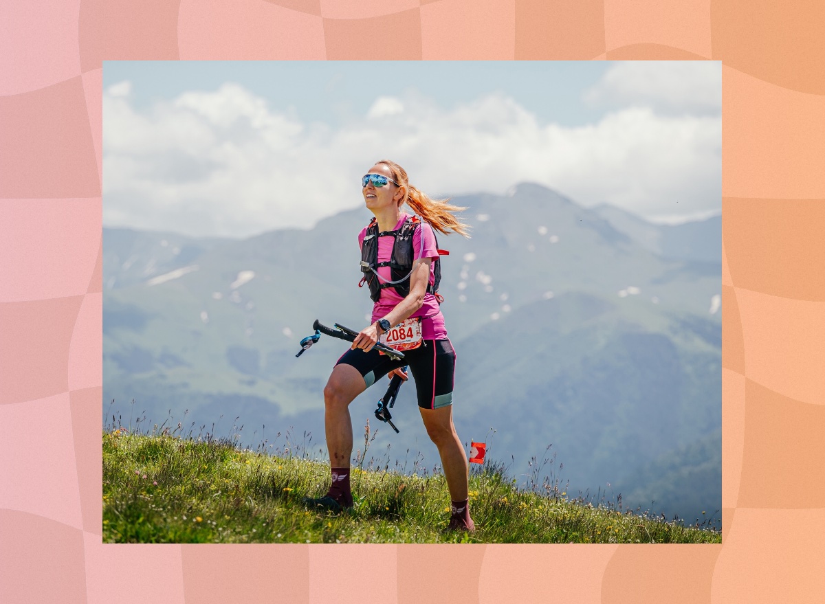 fit woman hiking uphill in the mountains on sunny day