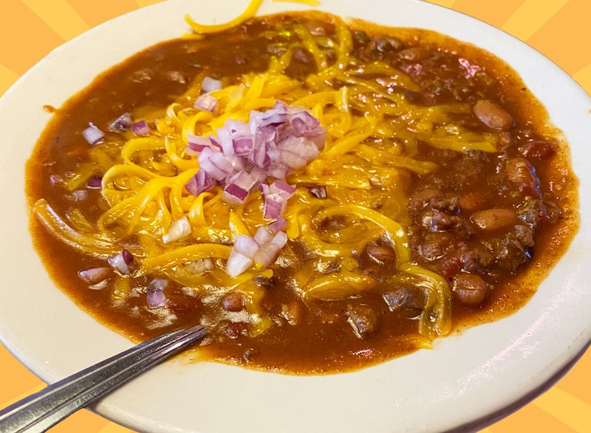 A bowl of chili from Texas Roadhouse set against a vibrant background