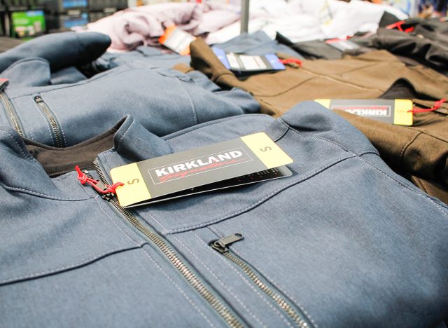 A view of stacks of folded Kirkland Signature zipper jackets, on display at a local Costco.