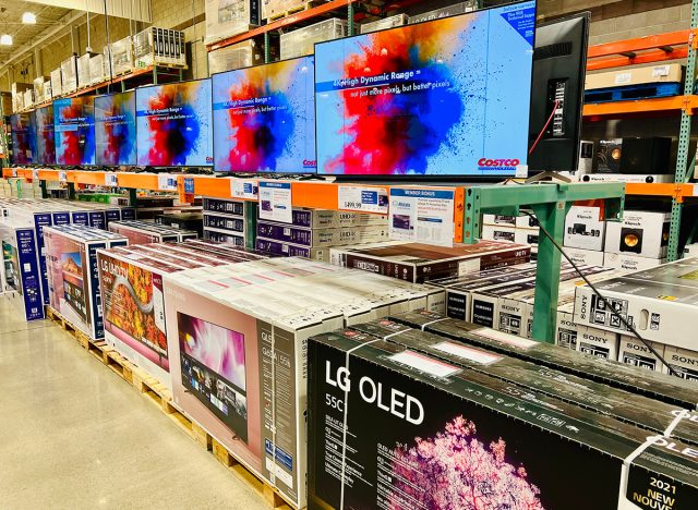 Large HDR and OLED televisions for sale inside Costco warehouse.