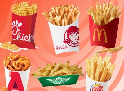 An array of fast-food french fries set against a vibrant background.