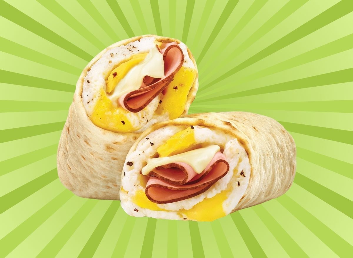 A black forest ham, egg, and cheese wrap from Subway, set against a vibrant background.