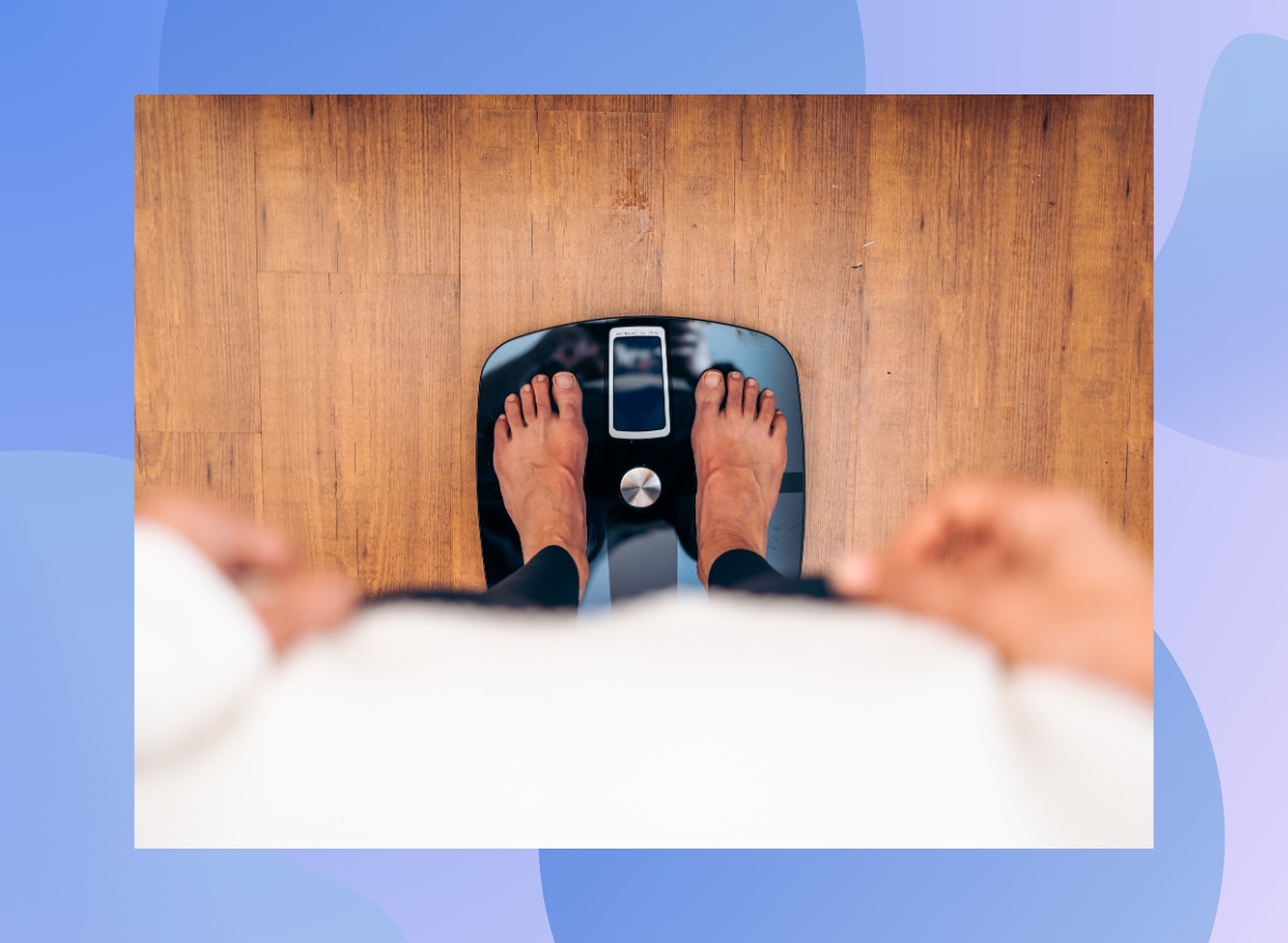 close-up of woman's feet on scale, weighing herself, downward view