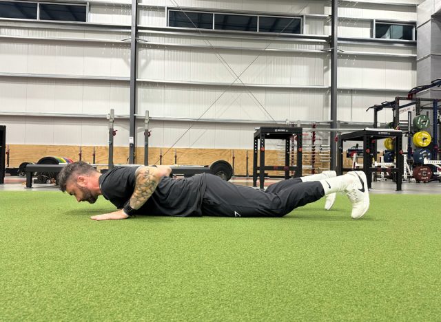 a trainer demonstrating how to come out of a plank