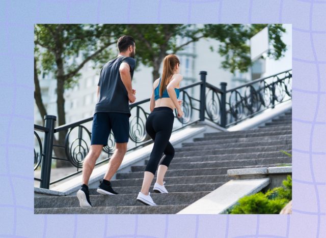 fitness couple brisk walking up staircase outdoors for exercise