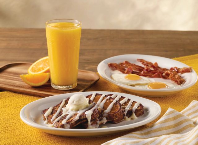 Cracker Barrel's Cinnamon Swirl French Toast Breakfast with bacon, eggs, and orange juice