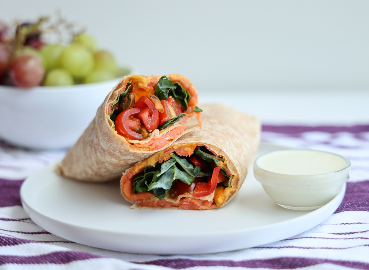 high protein smoked salmon and veggie recipe on a white plate with grapes in the background