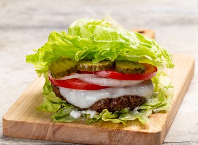 lettuce wrap burger on wooden cutting board