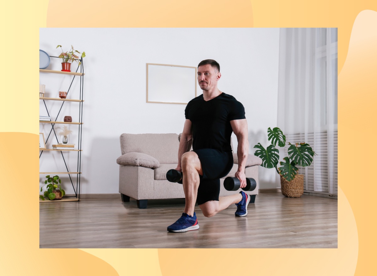 fit, muscular man doing dumbbell lunge at home