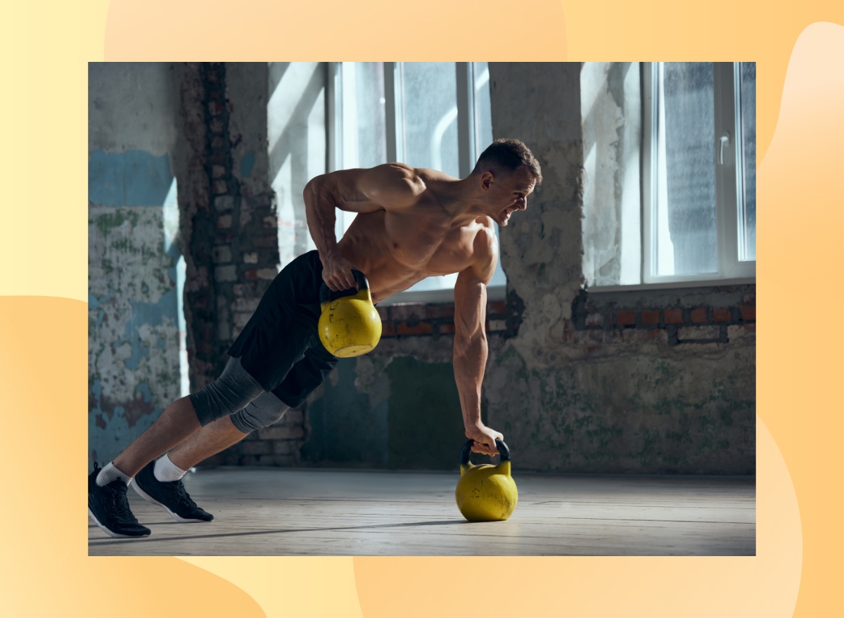 fit, muscular man doing kettlebell renegade rows exercise