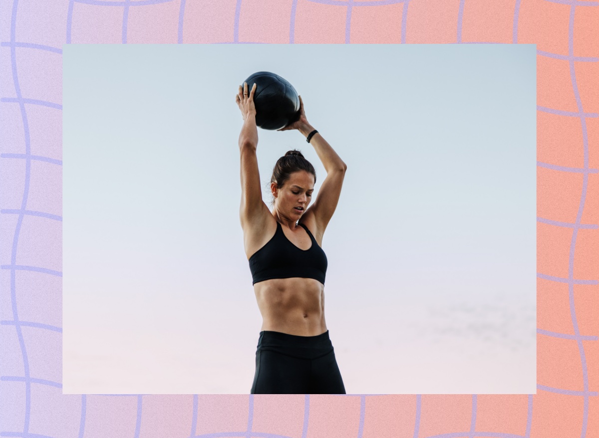 fit woman doing med ball slam