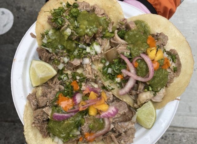 person holding plate of tacos from Carnitas el Viejon