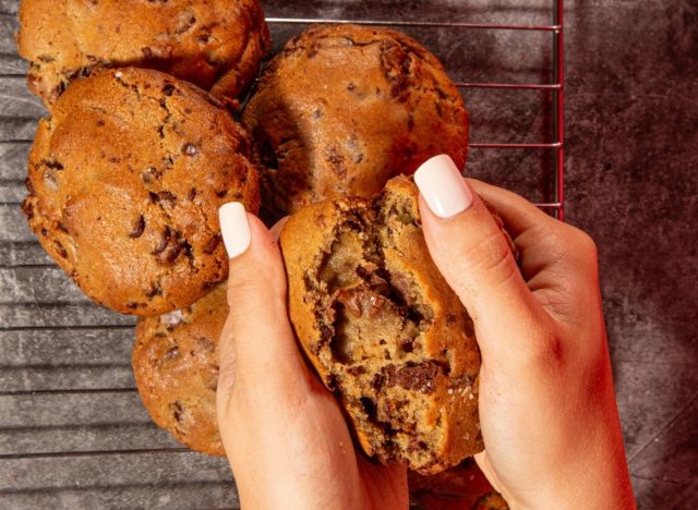 Person splitting Bang Cookie's Sea Salt Chocolate Chip Cookie in half