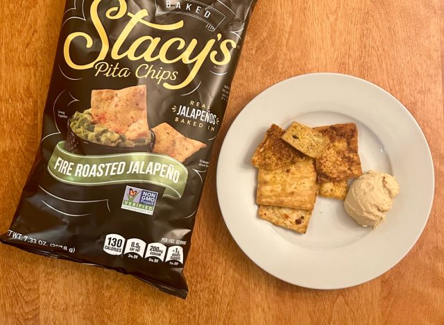 Stacy's Fire Roasted Jalapeño pita chips on a plate with hummus next to a bag of the pita chips