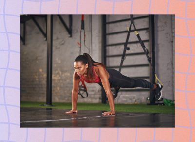 fit woman doing TRX pushups at a gym