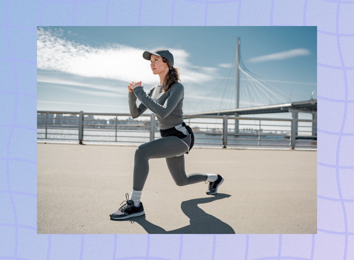 woman doing lunges outdoors at waterfront in cold weather