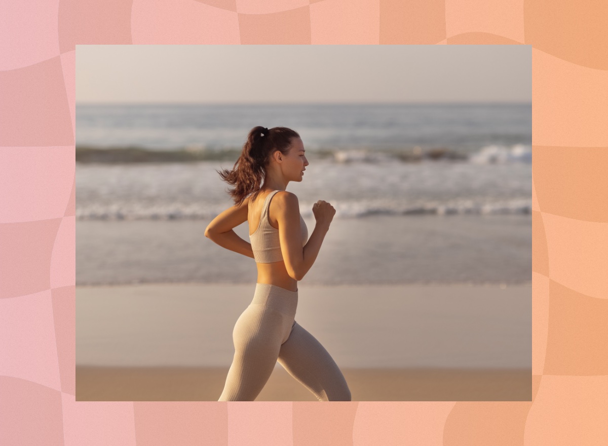 fit brunette woman jogging on the beach at sunset