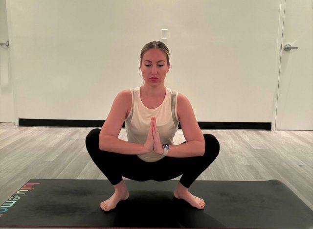 instructor demonstrating how to do a yogi squat