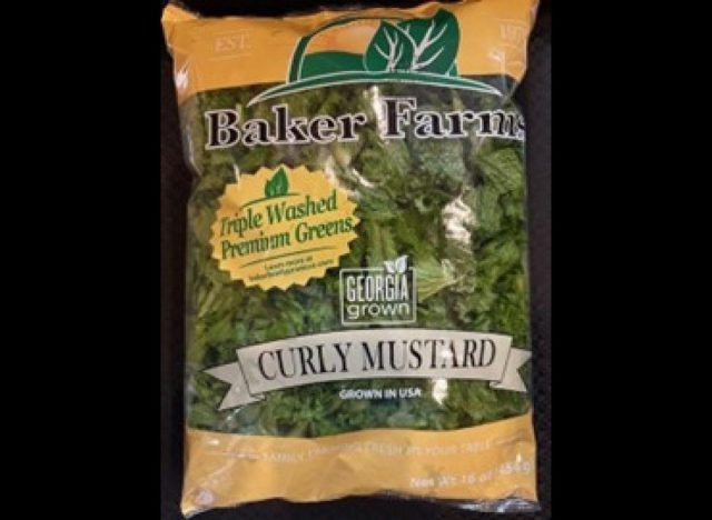 bag of Baker Farms Curly Mustard greens on black background